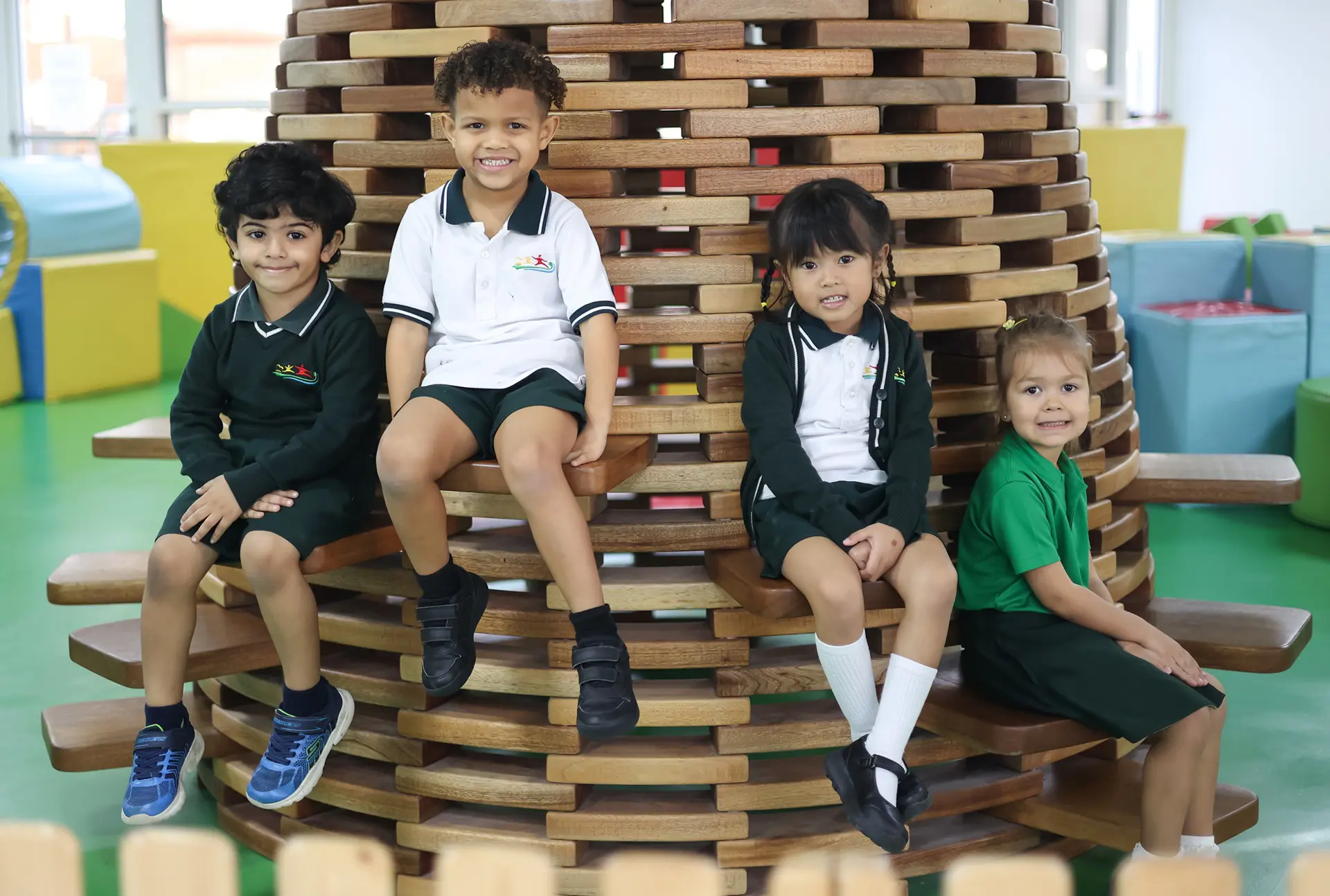 Early years students on indoor jungle gym