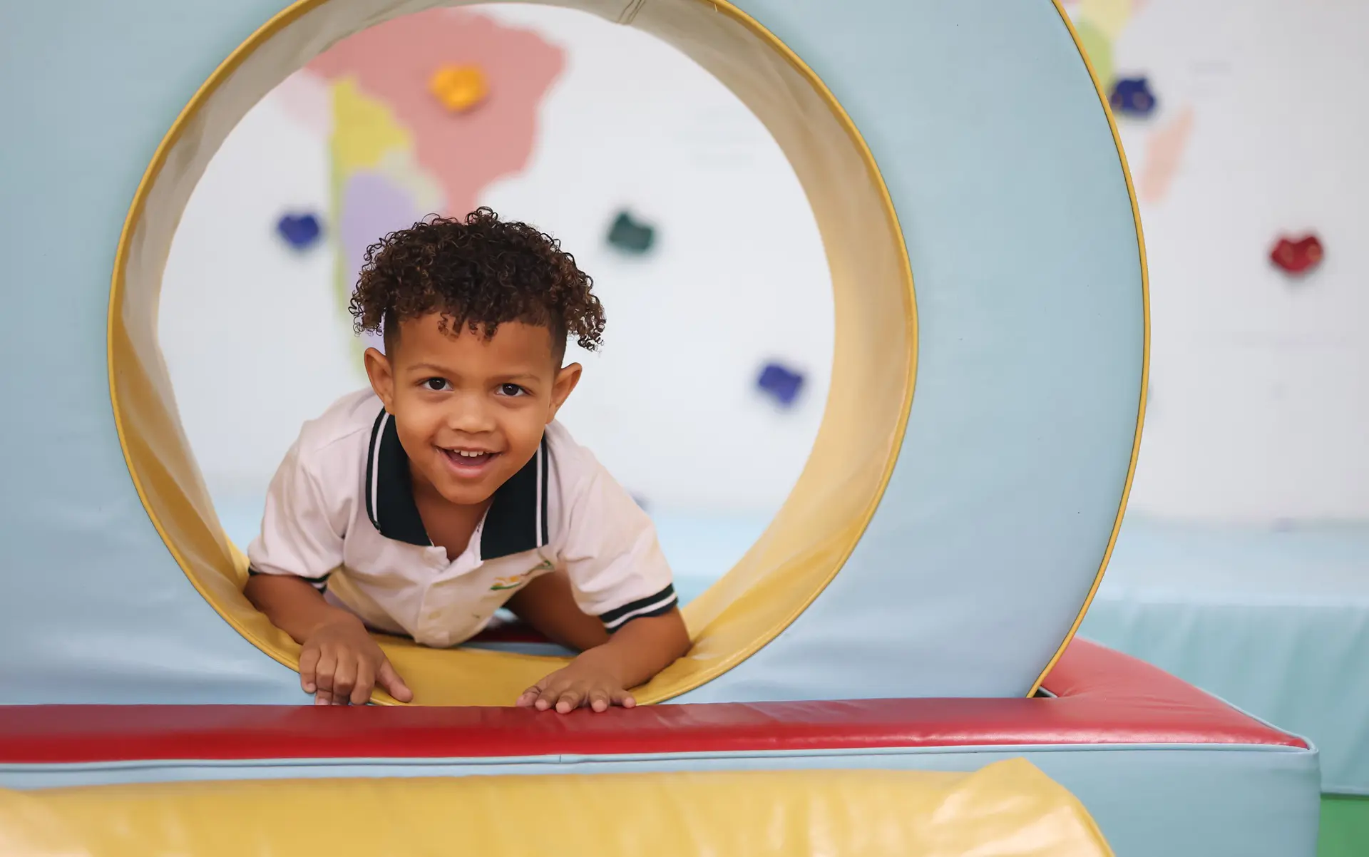Early years student playing on indoor playground