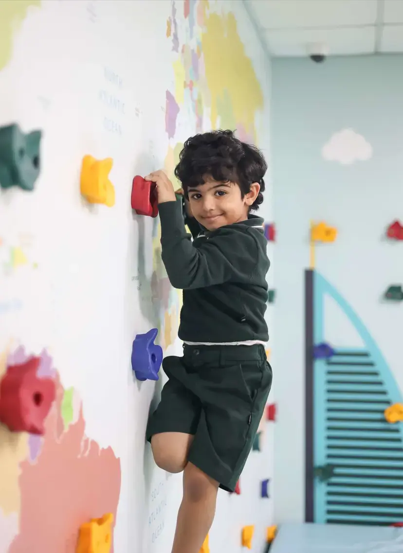 Child climbing on climbing wall
