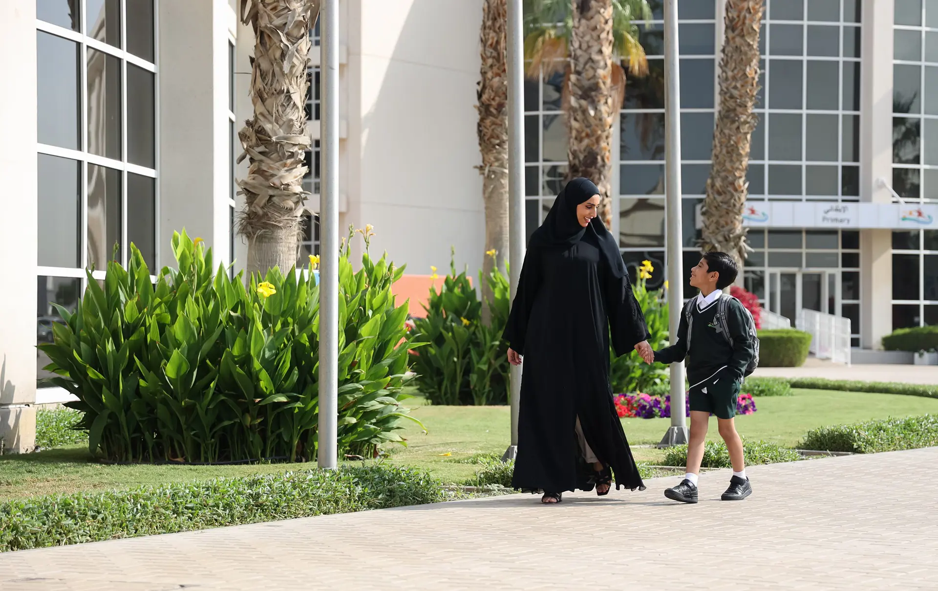 Mother walking student onto school campus