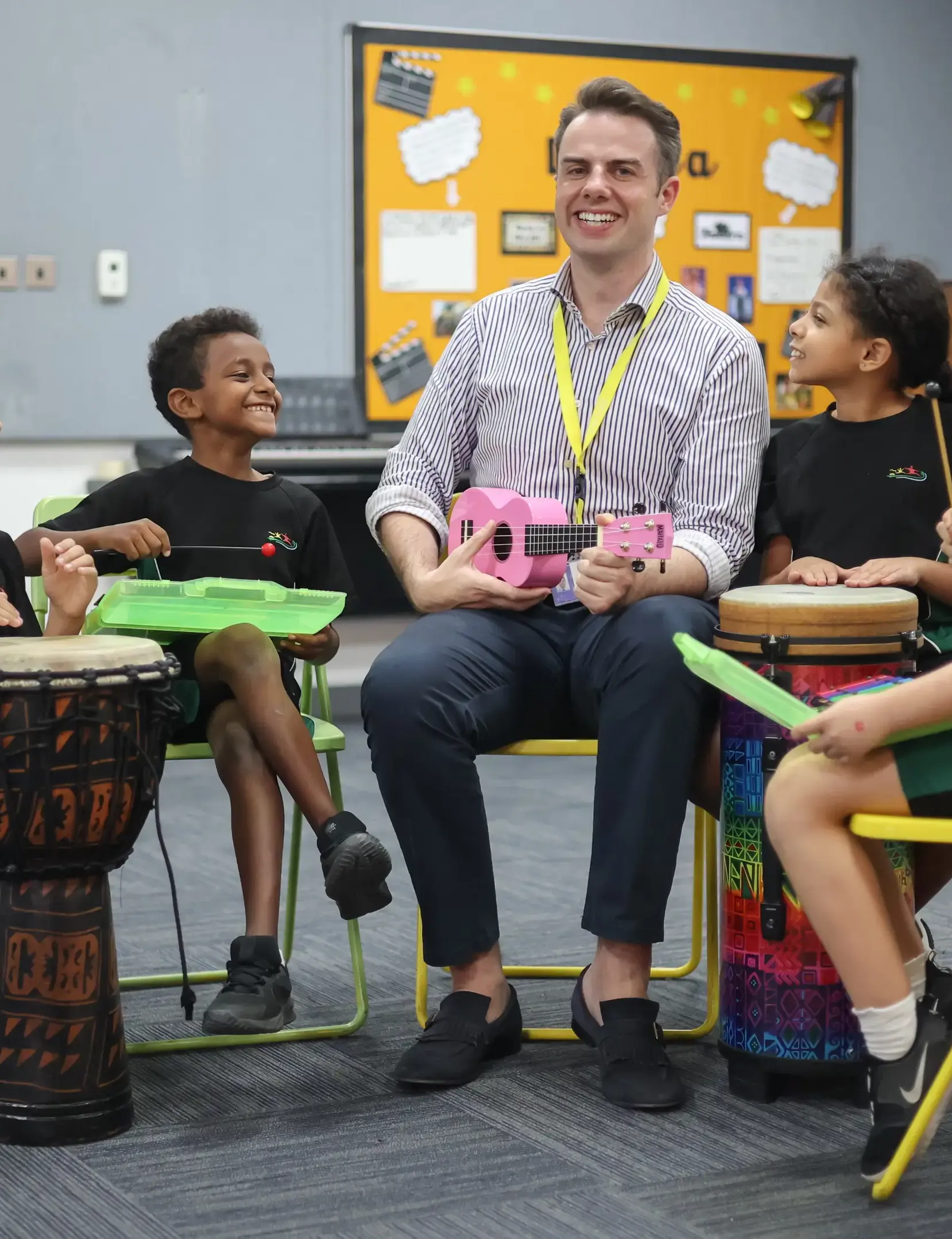 Teacher playing instrument with students