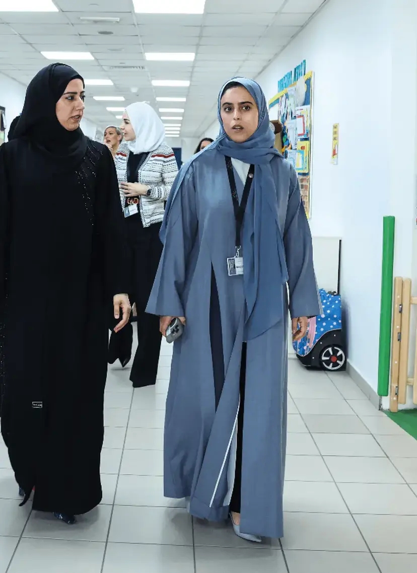 2 women walking in corridor