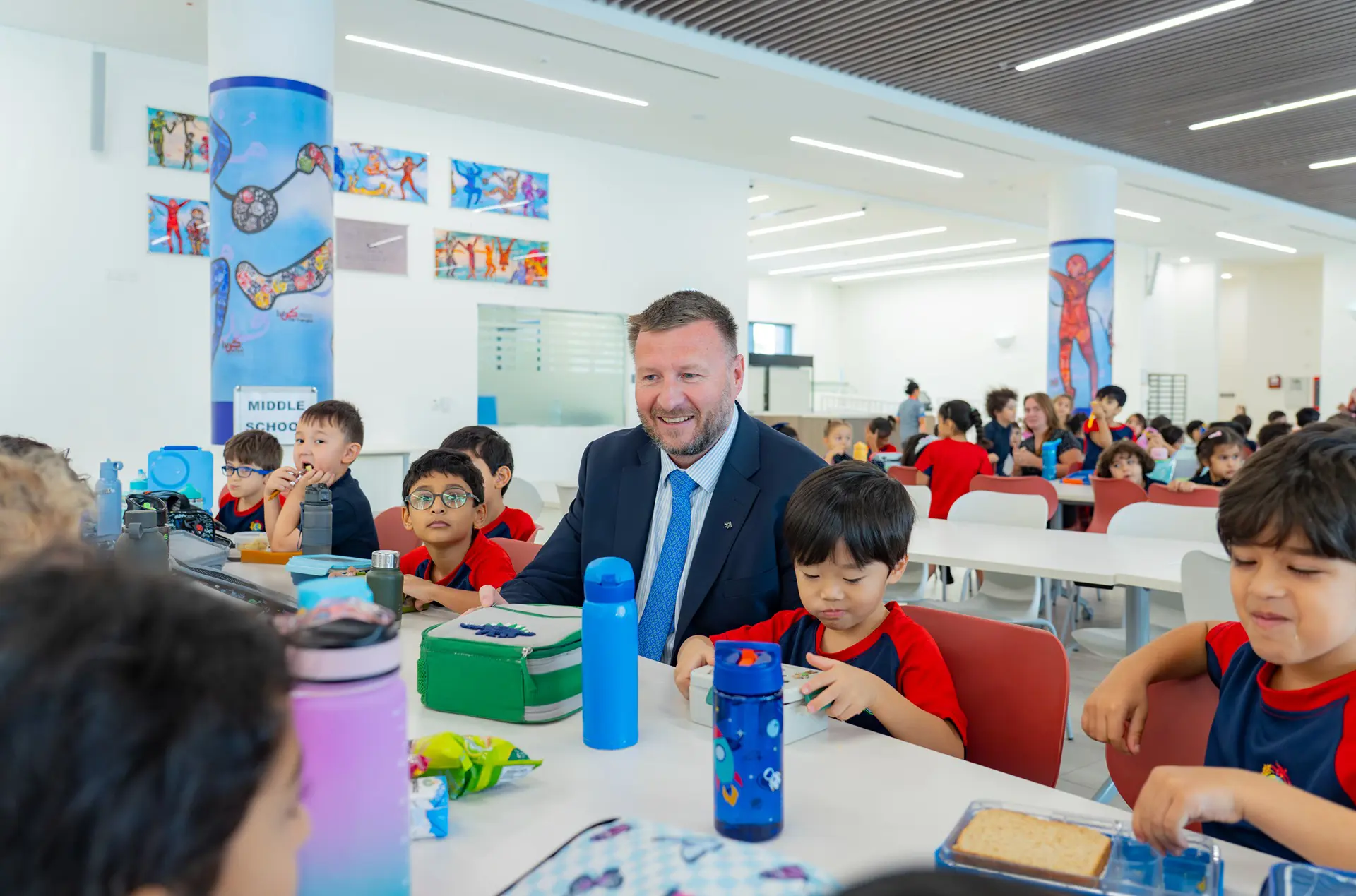 Director with children at lunch