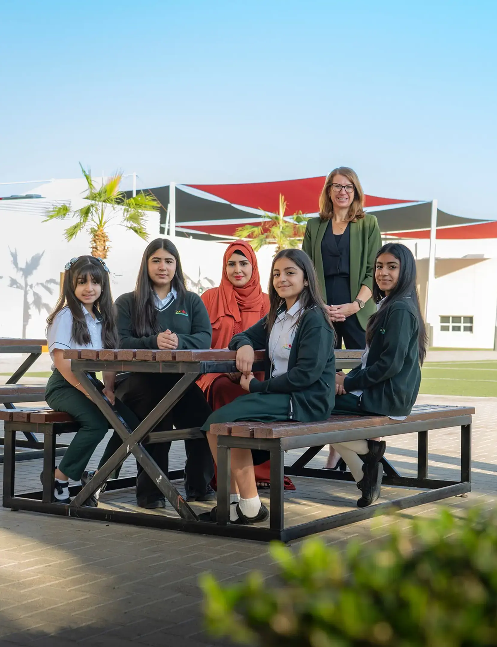 Students and teachers sat at table outside