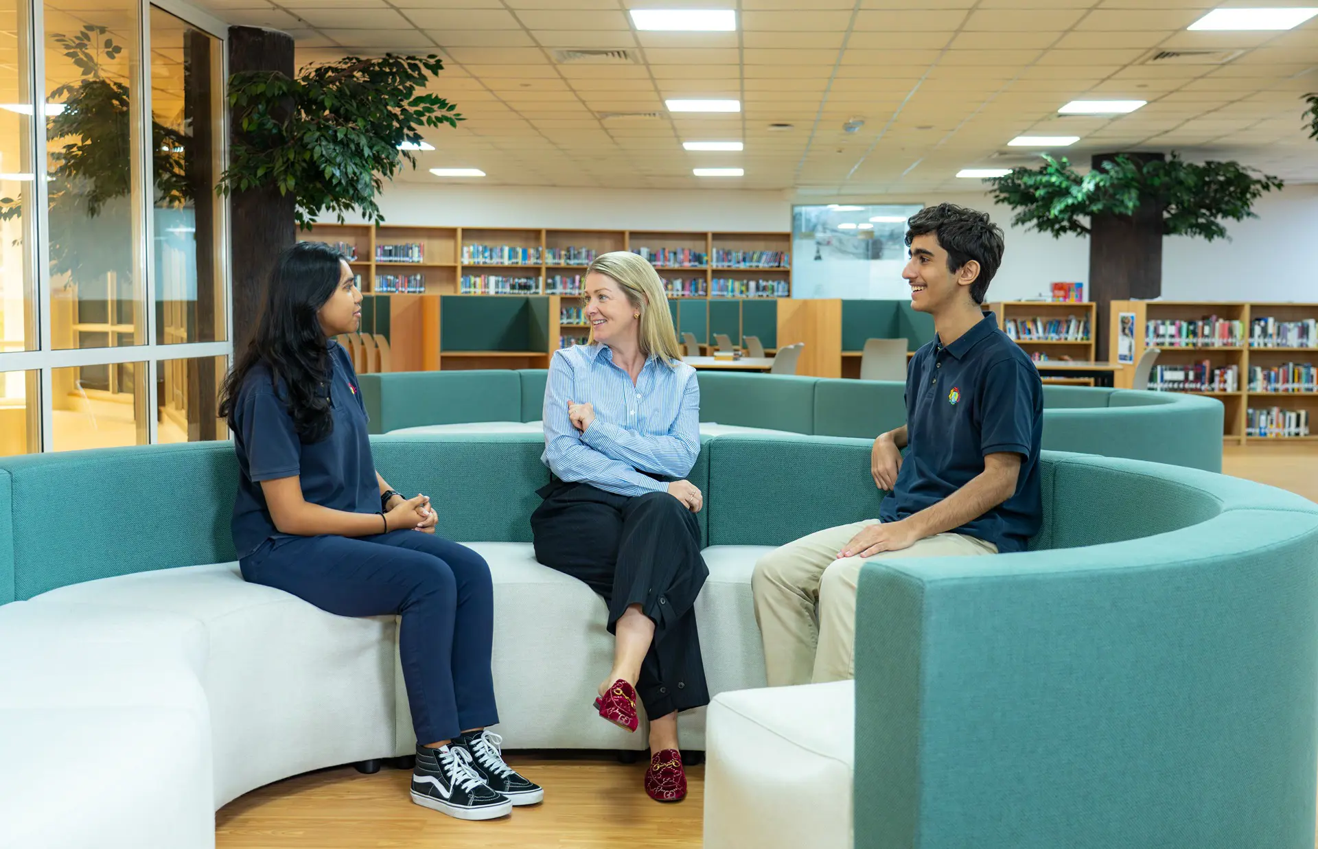High school students discussing with teacher