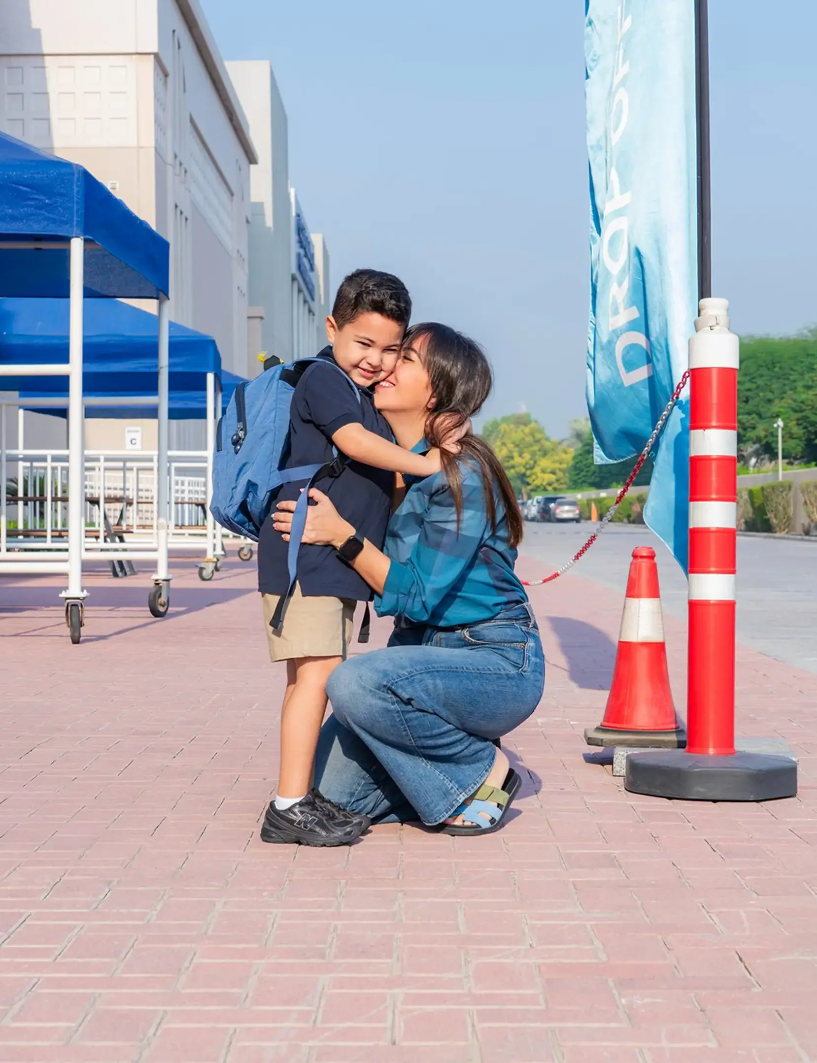 Parent hugging student on campus