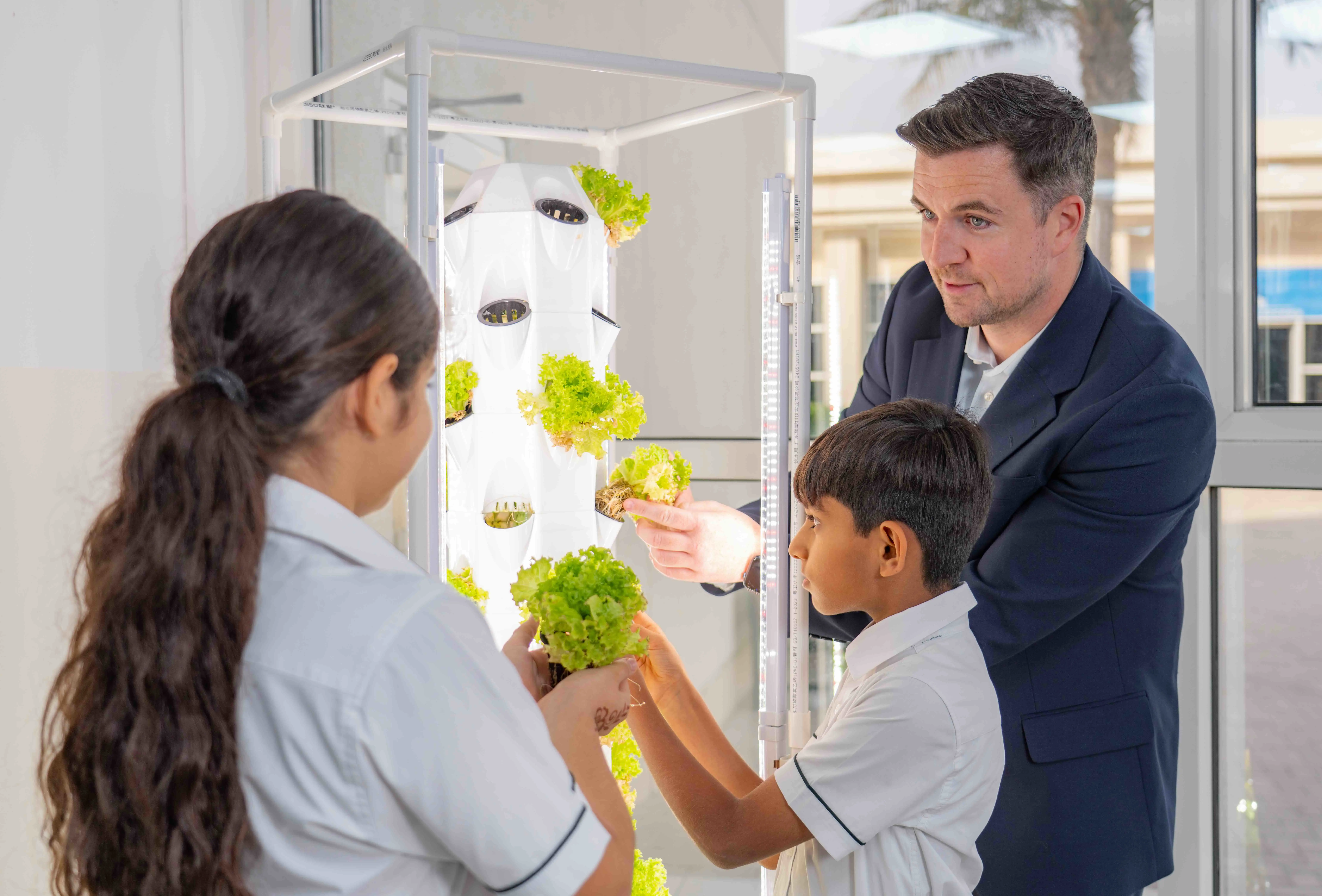 Teacher doing hydroponic gardening with students