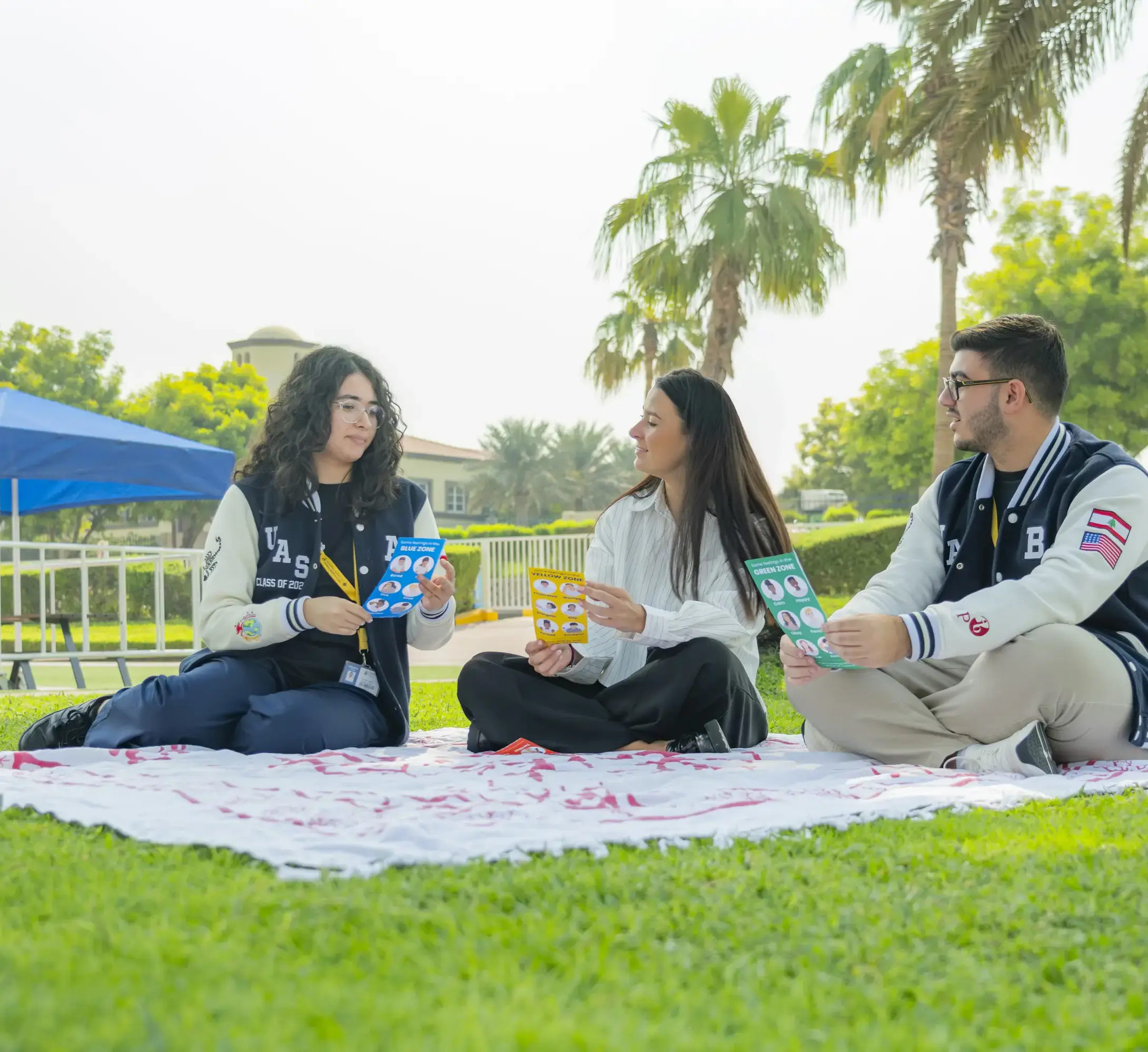 Three students sat in park together