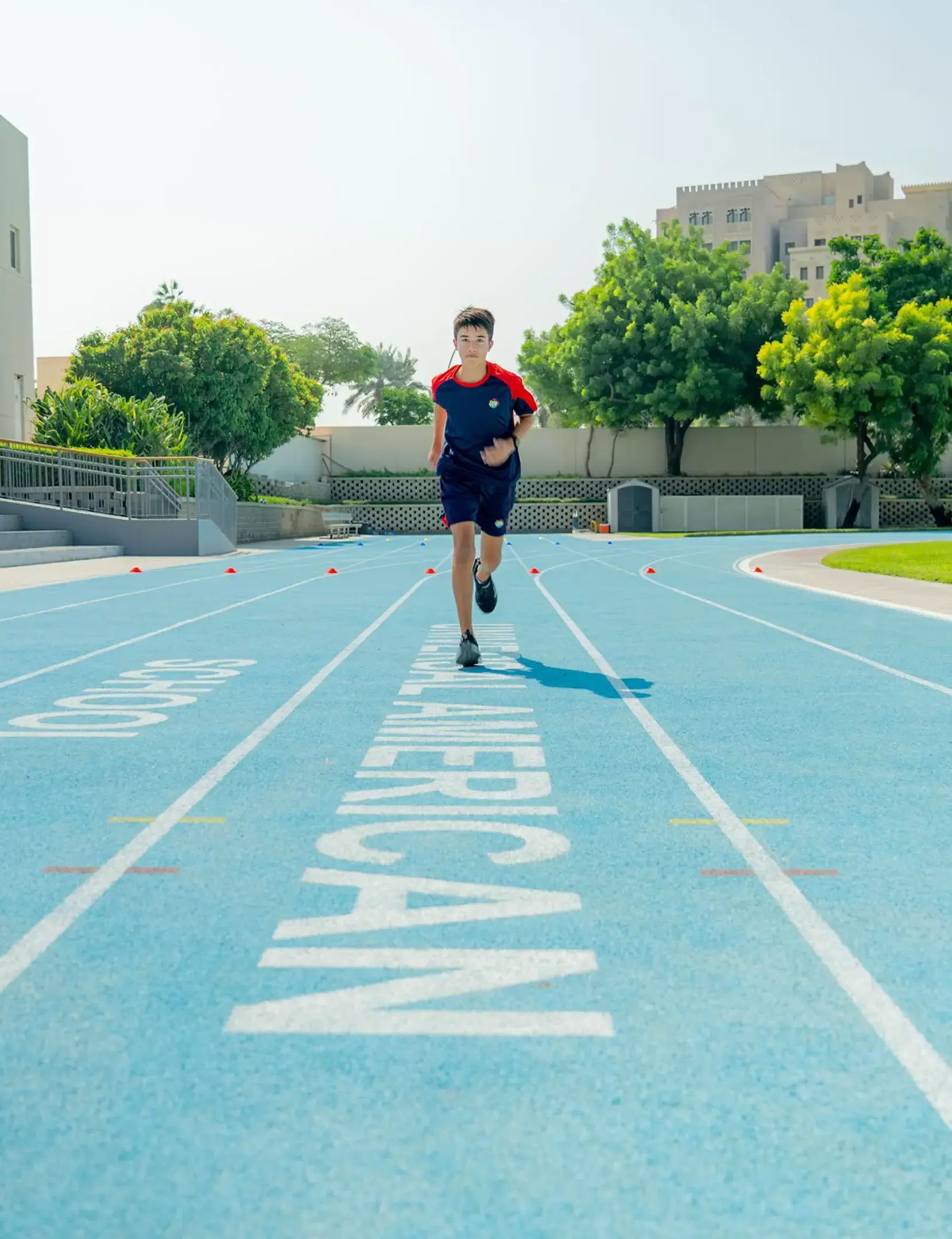 Student running on school track
