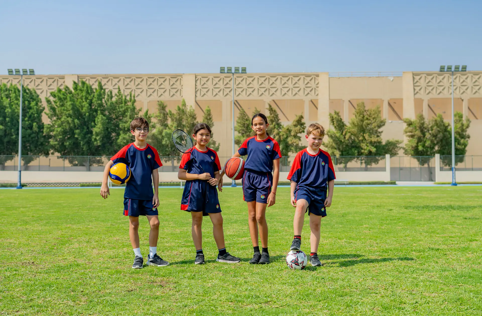 Students in football uniforms on football field