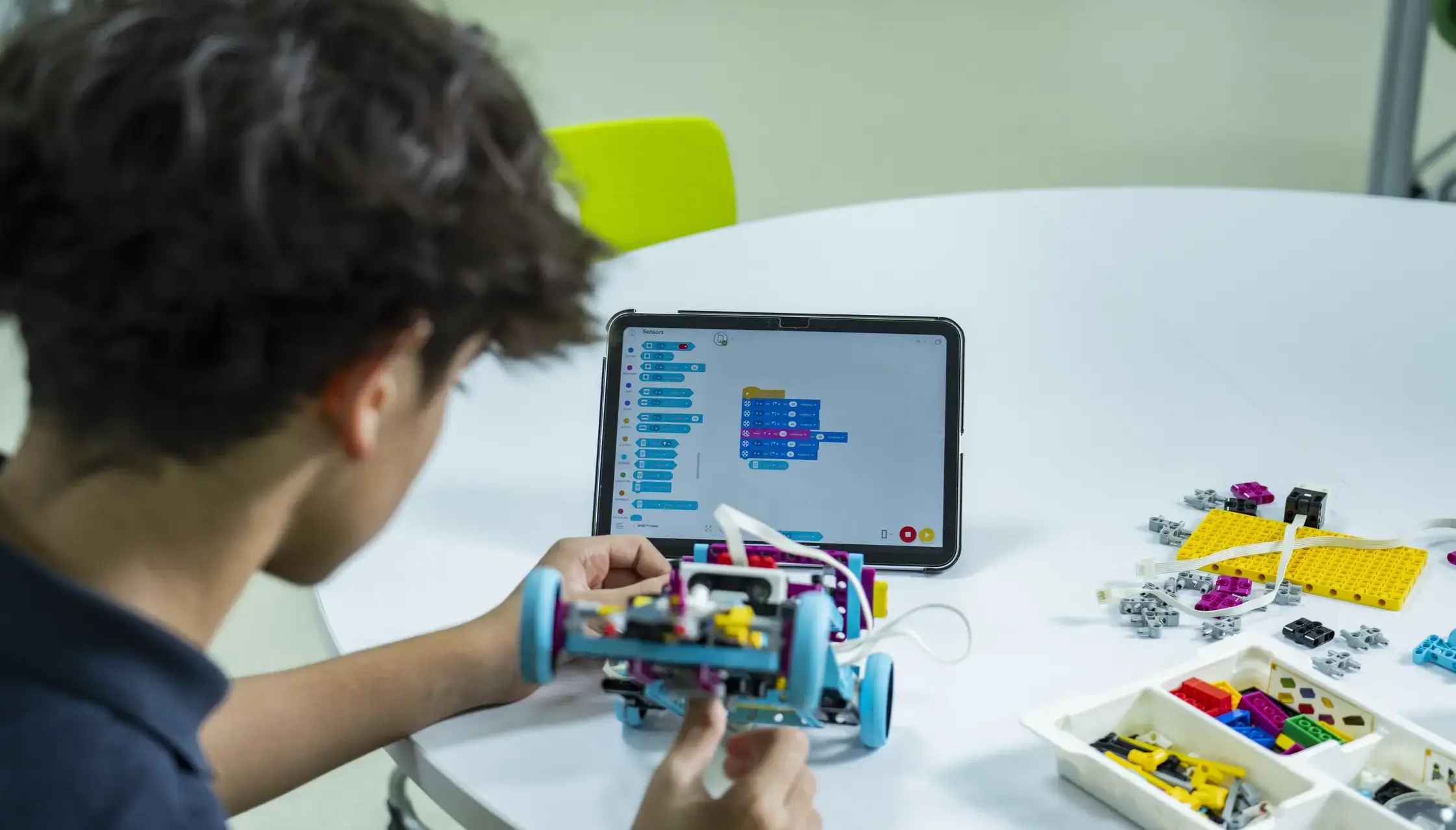 Student building robot with ipad
