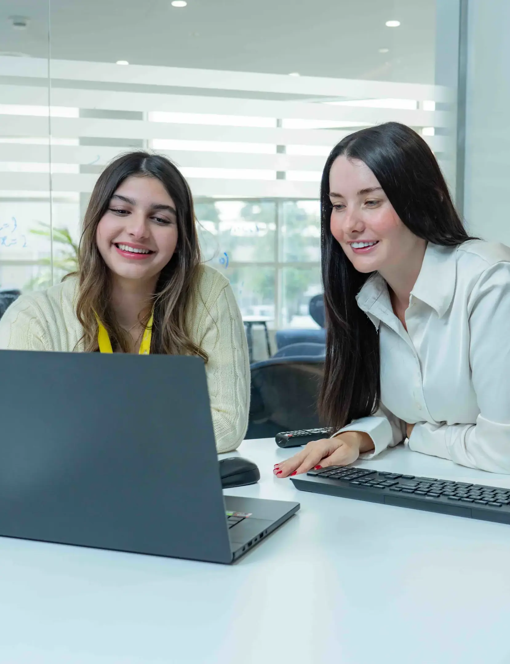 Two students doing schoolwork on laptop